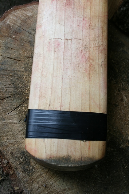 Covering up cricket bat damage with repair tape. Not a good idea.